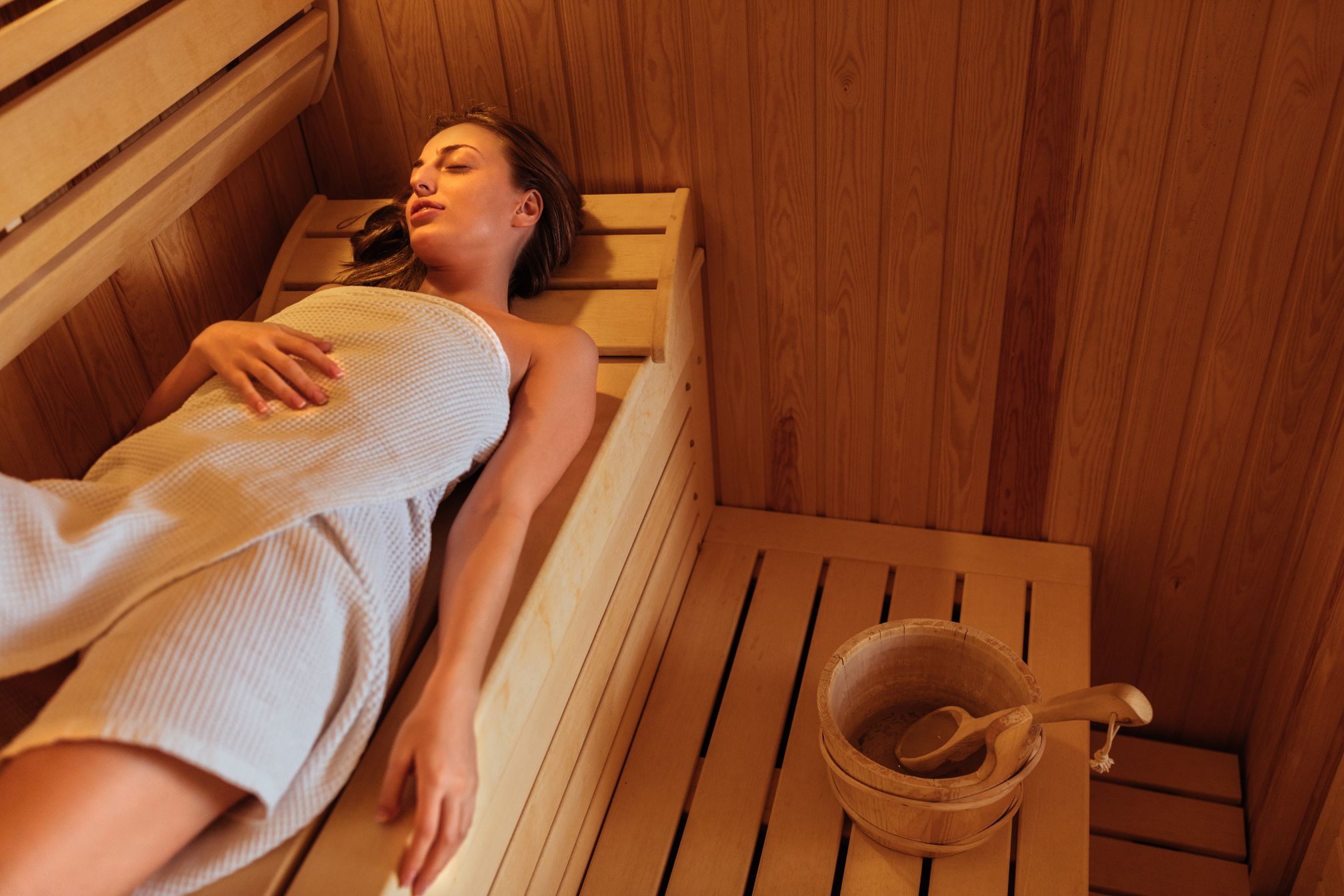 Woman lying in an infrared sauna.