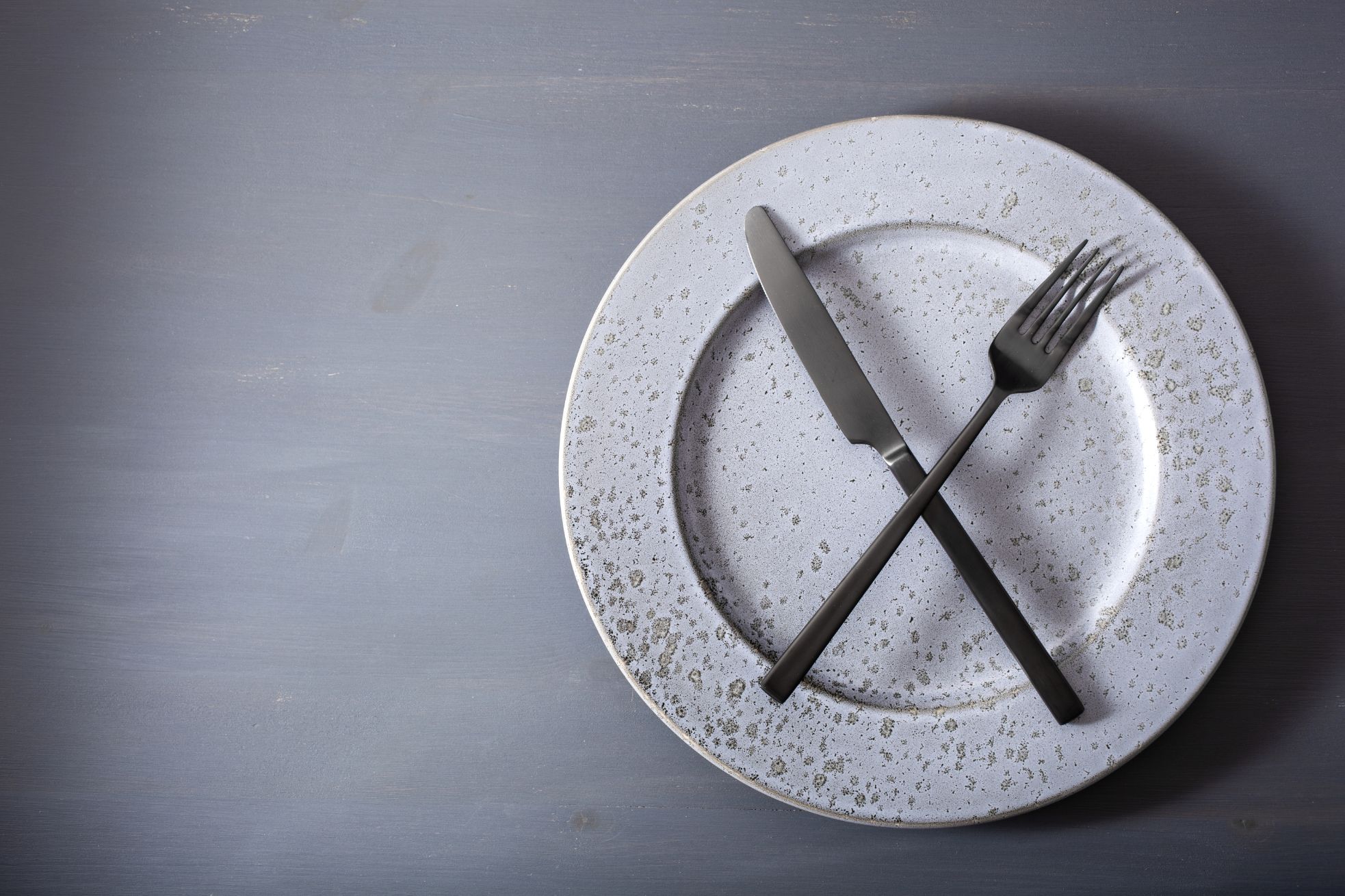 Empty dinner plate with silverware.