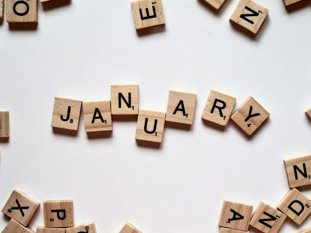 "January" spelled out in Scrabble tiles.
